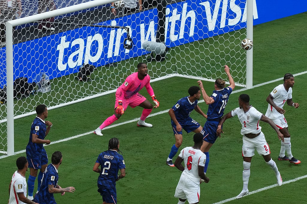 Englands Ezri Konsa (2) heads the ball past France goalkeeper Mike Maignan (16) to score their second goal during the World Cup third-place playoff soccer match between France and England in Miami Gardens