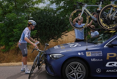 Spain's Xabier Azparren changes bike during the twelfth stage of the Tour de France cycling race with start in Circuit Nevers Magny-Cours and finish in Chalon-sur-Saone, France, Thursday, July 16, 2026. 