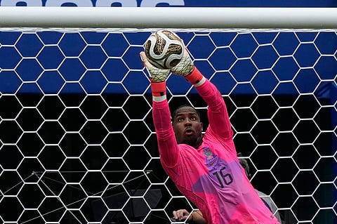 France goalkeeper Mike Maignan (16) makes a save during the World Cup third-place playoff soccer match between France and England in Miami Garden