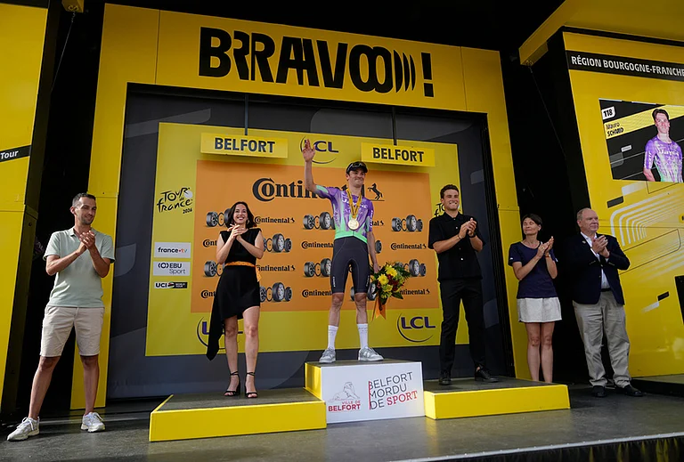 Switzerland's Mauro Schmid celebrates on the podium after winning the thirteenth stage of the Tour de France cycling race with start in Dole and finish in Belfort, France, Friday, July 17, 2026. - | Photo: AP/Mosa'ab Elshamy