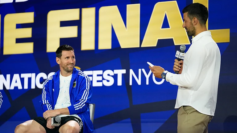 Argentina's Lionel Messi listens to tennis player Novak Djokovic during a news conference ahead of the World Cup final soccer match between Spain and Argentina in New York, Friday, July 17, 2026 - (AP Photo/Frank Franklin II)