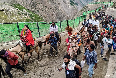 Pilgrims proceed towards the holy cave shrine of Amarnath during the ongoing 'Amarnath Yatra', in Jammu.