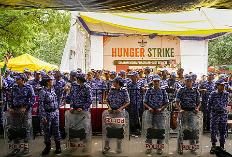 Security personnel stand guard as activist Sonam Wangchuk, unseen, who has been on an indefinite hunger strike for 21 days, is shifted to a hospital from Jantar Mantar, in New Delhi, Saturday, July 18, 2026. 