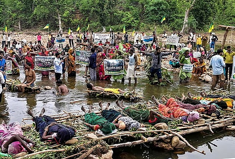 Tribals and farmers affected by the Ken-Betwa river-linking project stage a symbolic ‘Chita Andolan’ (pyre protests), Jal Satyagraha and ‘hanging satyagraha’ by placing nooses around their necks, over their demands of better compensation and rehabilitation, in Chhatarpur district, Madhya Pradesh, Friday, July 17, 2026. 