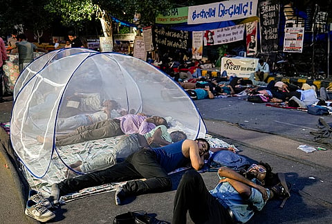 Supporters of the Cockroach Janata Party (CJP) rest at Jantar Mantar before activist Sonam Wangchuk, unseen, who has been on an indefinite hunger strike for 21 days, is shifted to a hospital for medical care, in New Delhi, early Saturday, July 18, 2026. 