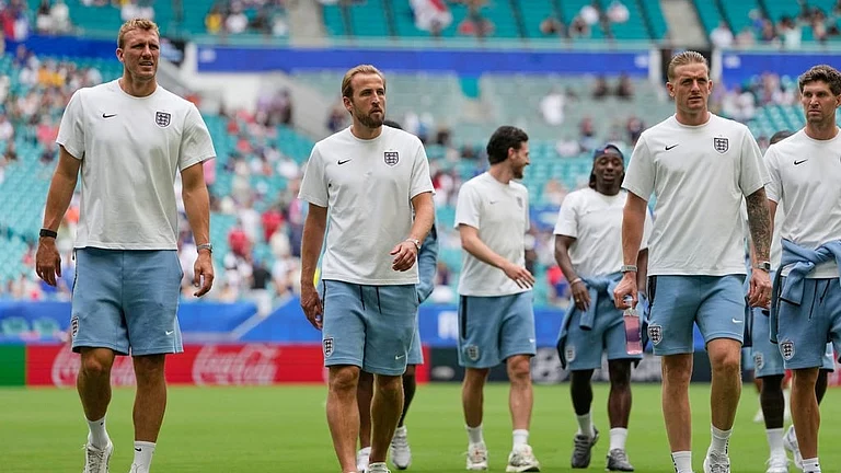 England's Dan Burn, left, Harry Kane, center, and goalkeeper Jordan Pickford, right front, lead the team off the pitch after their arrival for the World Cup third-place playoff soccer match between France and England in Miami Gardens - Rebecca Blackwell/AP Photo