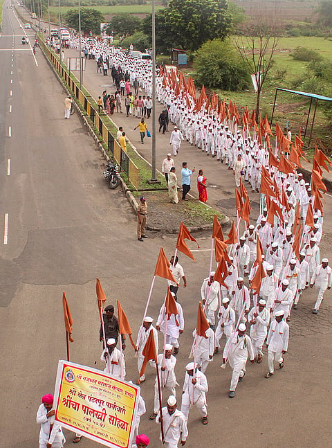 People take part in a procession to observe 'Sant Gajanan Maharaj Palkhi', known as Maharashtra's most disciplined procession, it covers nearly 1,200 km featuring over 700 Warkaris, in Solapur.