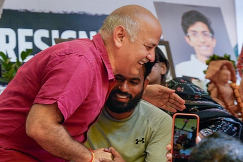 AAP leader Manish Sisodia with Cockroach Janata Party (CJP) founder Abhijeet Dipke during a protest demanding Union Education Minister Dharmendra Pradhan's resignation over alleged irregularities in the NEET examination, at the Jantar Mantar in New Delhi.
