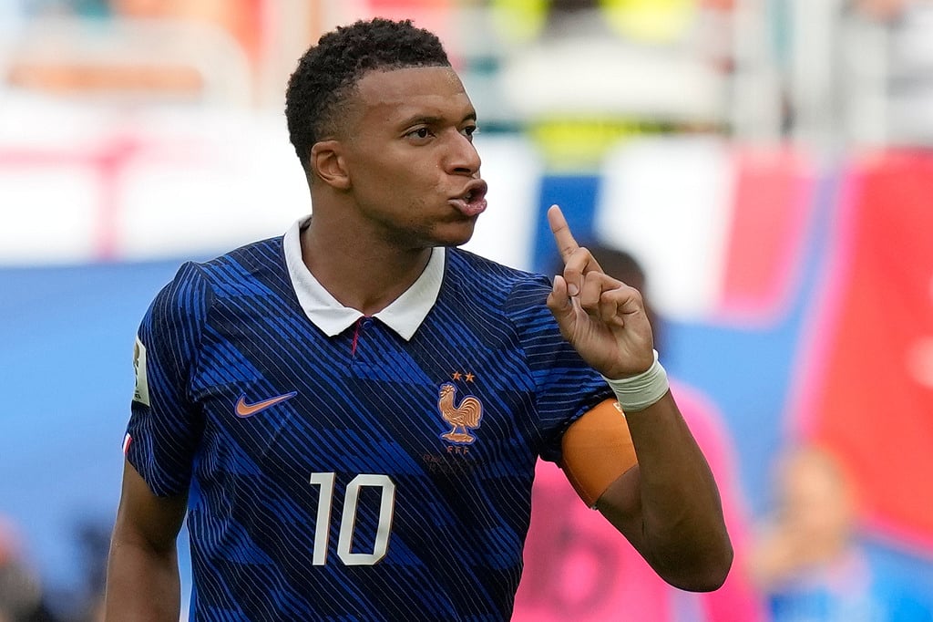 Frances Kylian Mbappe (10) reacts after scoring his sides third goal during the World Cup third-place playoff soccer match between France and England in Miami Gardens