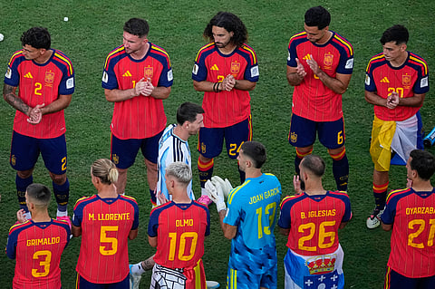 Argentina's Lionel Messi (10) walks between Spain players during the medal ceremony after the World Cup final soccer match between Spain and Argentina in East Rutherford, N.J., near New York, Sunday, July 19, 2026.