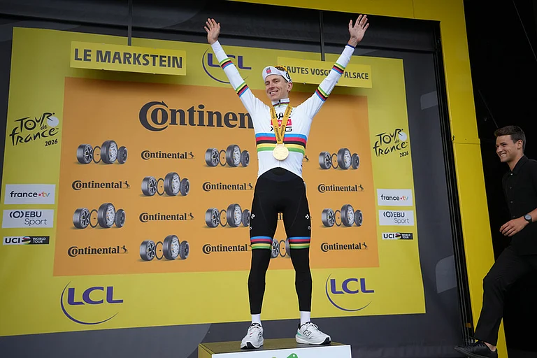 Slovenia's Tadej Pogacar celebrates on the podium after winning the fourteenth stage of the Tour de France cycling race, with start in Mulhouse and finish in Le Markstein Fellering, France. - | Photo: AP/Thibault Camus