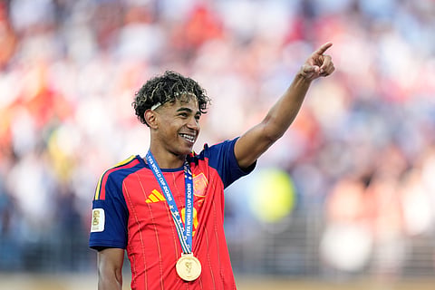 Spain's Lamine Yamal gestures, wearing his medal, after winning the World Cup final soccer match between Spain and Argentina in East Rutherford, N.J., near New York, Sunday, July 19, 2026.
