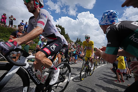Slovenia's Tadej Pogacar, wearing the overall leader's yellow jersey, rides in the pack during the fourteenth stage of the Tour de France cycling race, with start in Mulhouse and finish in Le Markstein Fellering, France.