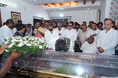 Karnataka Chief Minister DK Shivakumar pays last respects to the mortal remains of Chennamma Deve Gowda, wife of former Prime Minister H D Deve Gowda, at their residence, in Bengaluru, late Saturday, July 18, 2026. Chennamma Deve Gowda passed away on Saturday, at the age of 89 after suffering a massive cardiac arrest at a private hospital in Bengaluru.
