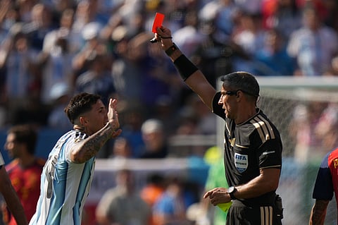 Referee Slavko Vincic, of Slovenia shows a red card to Argentina's Enzo Fernandez (24) during the World Cup final soccer match between Spain and Argentina in East Rutherford, N.J., near New York, Sunday, July 19, 2026.