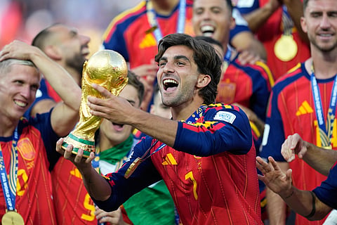 Spain's Ferran Torres celebrates with the trophy after winning the World Cup final soccer match between Spain and Argentina in East Rutherford, N.J., near New York, Sunday, July 19, 2026.