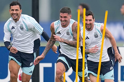 Argentina's Lionel Messi, Rodrigo Javier De Paul and Leandro Paredes, from right, during a training session on the eve of the World Cup final soccer match in Morristown, N.J.