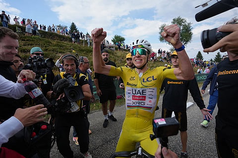 Slovenia's Tadej Pogacar, wearing the overall leader's yellow jersey, celebrates after winning the fourteenth stage of the Tour de France cycling race with start in Mulhouse and finish in Le Markstein Fellering, France.
