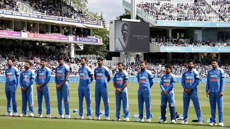 India players stand for a minute of silence in tribute to late cricketer Sir Garfield Sobers before the start of the third ODI against England at Lord's, London on Sunday, July 19, 2026. - AP Photo/Steven Paston