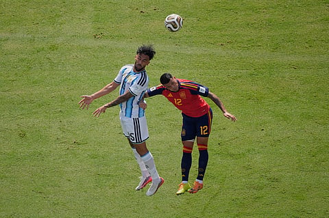 Argentina's Nico Gonzalez (15) jumps for the ball with Spain's Pedro Porro (12) during the World Cup final soccer match between Spain and Argentina in East Rutherford, N.J., near New York, Sunday, July 19, 2026.