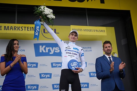 France's Paul Seixas, wearing the best young rider's white jersey, celebrates on the podium after the fourteenth stage of the Tour de France cycling race with start in Mulhouse and finish in Le Markstein Fellering, France.