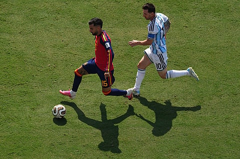 Spain's Victor Munoz (25) in action in front of Argentina's Lionel Messi (10) during the World Cup final soccer match between Spain and Argentina in East Rutherford, N.J., near New York, Sunday, July 19, 2026.