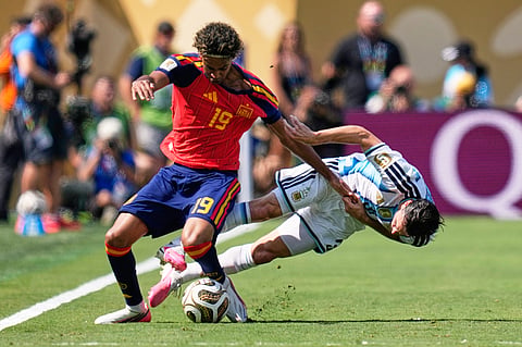 Argentina's Nicolas Tagliafico, right, fights for the ball with Spain's Lamine Yamal during the World Cup final soccer match between Spain and Argentina in East Rutherford, N.J., near New York, Sunday, July 19, 2026.