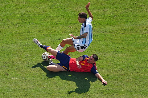 Spain's Aymeric Laporte (14) tackles Argentina's Gonzalo Montiel (4) during the World Cup final soccer match between Spain and Argentina in East Rutherford, N.J., near New York, Sunday, July 19, 2026.
