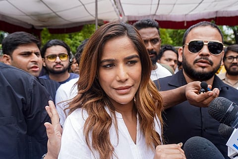 Actor Poonam Pandey arrives to support Cockroach Janata Party (CJP) founder Abhijeet Dipke during a protest demanding Union Education Minister Dharmendra Pradhan's resignation over alleged irregularities in the NEET examination, at the Jantar Mantar in New Delhi.