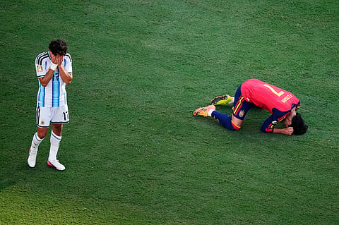 Argentina's Giuliano Simeone (17) is dejected as Spain's Ferran Torres (7) celebrates at the end of the World Cup final soccer match between Spain and Argentina in East Rutherford, N.J., near New York, Sunday, July 19, 2026.