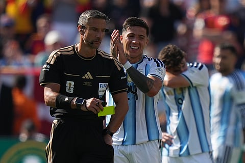 Argentina's Enzo Fernandez (24) applauds Referee Slavko Vincic, of Slovenia after receiving a yellow card during the World Cup final soccer match between Spain and Argentina in East Rutherford, N.J., near New York, Sunday, July 19, 2026.