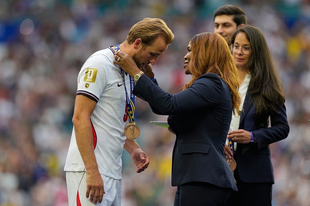 Englands Harry Kane is presented with a the bronze medal by FIFA council member Sonia Fulford during the World Cup third-place playoff soccer match between France and England in Miami Gardens