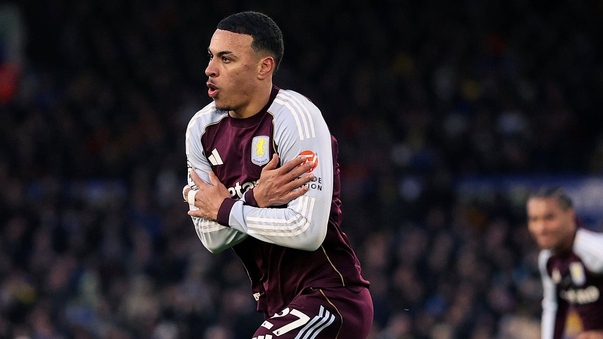 Morgan Rogers is captured celebrating after scoring for Aston Villa, sprinting across the pitch with his arms crossed over his chest in his trademark celebration - X/AVFCOfficial