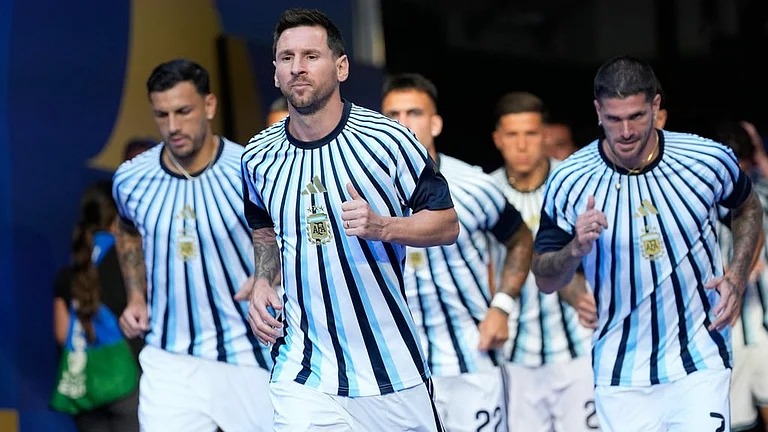 Argentina's Lionel Messi, center, walks to the field for warm up before the World Cup round of 32 soccer match against Cape Verde in Miami Gardens - Rebecca Blackwell/AP Photo