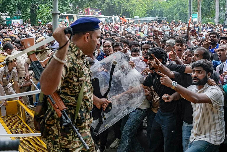 Security personnel stop Cockroach Janata Party (CJP) supporters as they raise slogans during a protest march, at Patel Chowk, in New Delhi, Monday, July 20, 2026. Delhi Police is on high alert ahead of the Monsoon Session of Parliament and CJP's proposed "Chalo Sansad" march on Monday. - Money Sharma