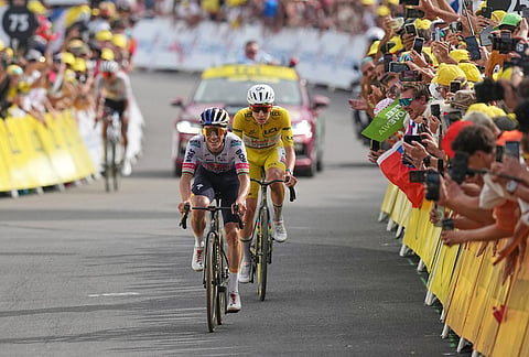 Belgium's Remco Evenepoel steers his bicycle to cross the finish line ahead Slovenia's Tadej Pogacar and win the fifteenth stage of the Tour de France cycling race, from Champagnole to the Plateau de Solaison, France, Sunday, July 19, 2026. 