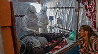 | Photo: AP/Moses Sawasawa : Health workers tend to an Ebola patient at the Rwampara Treatment Center in Ituri, Congo.