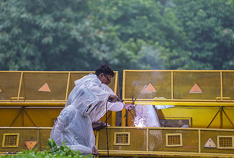 A worker carries out welding work on a barricade ahead of the Cockroach Janata Party's (CJP) protest march, at the Jantar Mantar, in New Delhi, early Monday, July 20, 2026. 