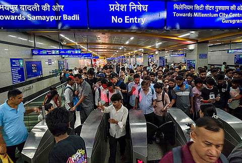 Commutters exit the Central Secretariat metro station after it was temporarily closed due to security reasons, in New Delhi, Monday, July 20, 2026. 