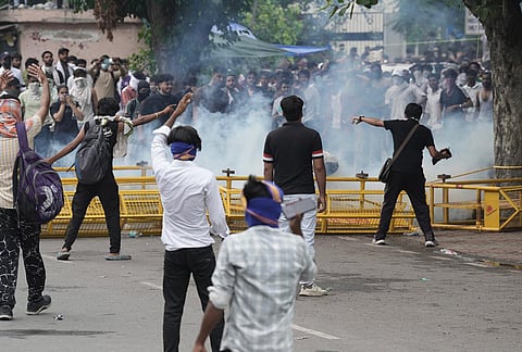 Security personnel fire tear gas shells to disperse Cockroach Janata Party (CJP) supporters during a protest march, near the Parliament in New Delhi, Monday, July 20, 2026. 