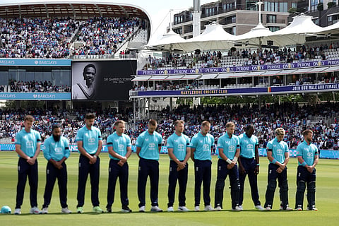 England players stand for a minute of silence in tribute to late cricketer Garfield Sobers at the start of the third ODI between England and India, at Lord's cricket ground, London.