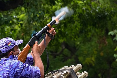 Police fire tear gas shells to disperse supporters of the Cockroach Janta Party scuffle with police as they attempt to march toward India's Parliament, demanding the resignation of the education minister, in New Delhi, India.