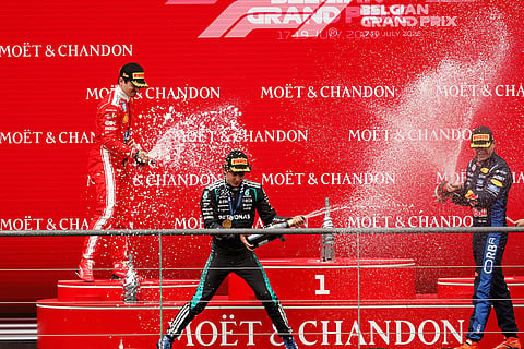 Mercedes driver Andrea Kimi Antonelli of Italy, center, celebrates on the podium with Ferrari driver Charles Leclerc of Monaco, left, and third place Red Bull driver Max Verstappen of the Netherlands, after winning the Formula One Grand Prix at the Spa-Francorchamps racetrack in Spa, Belgium.
