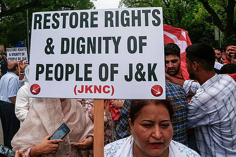 Jammu and Kashmir National Conference (JKNC) workers stage a protest outside Jammu and Kashmir House demanding the restoration of statehood to Jammu and Kashmir, in New Delhi.