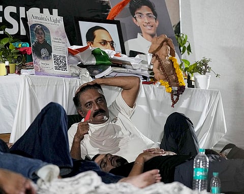 Actor Prakash Raj and others rest ahead of Cockroach Janata Party's (CJP) protest march, at Jantar Mantar, in New Delhi, Monday, July 20, 2026. 