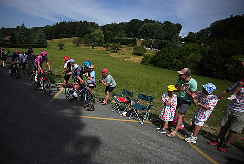 Spectators cheer riders during the fifteenth stage of the Tour de France cycling race, from Champagnole to Plateau de Solaison, France, Sunday, July 19, 2026. 