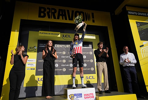 Quinn Simmons of the U.S. celebrates on podium after winning the most combative rider award of the fifteenth stage of the Tour de France cycling race, from Champagnole to Plateau de Solaison, France, Sunday, July 19, 2026. 