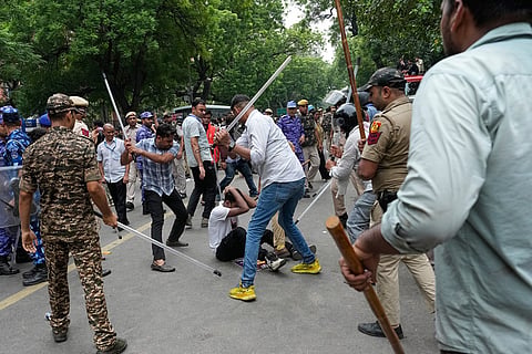 Police use batons to disperse supporters of the Cockroach Janta Party as they attempt to march toward India's Parliament, demanding the resignation of the education minister, in New Delhi, India.