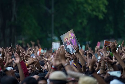 Cockroach Janata Party (CJP) supporters hold a portrait and raise slogans, near Jantar Mantar ahead of a protest march, in New Delhi, early Monday, July 20, 2026. 