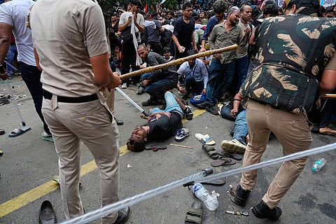 Police use batons to disperse supporters of the Cockroach Janta Party as they attempt to march toward India's Parliament, demanding the resignation of the education minister, in New Delhi, India.